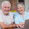 Senior couple making online payment on their HVAC invoice