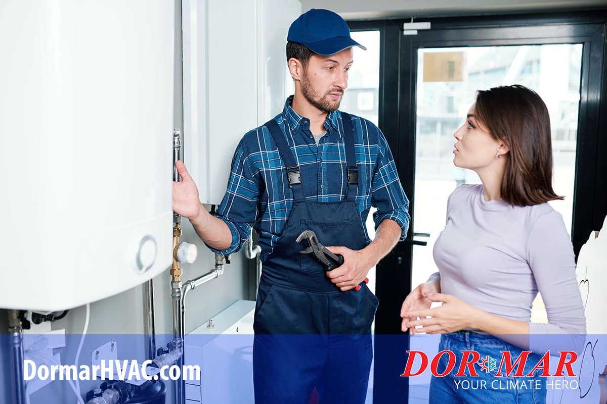 Homeowner talks with HVAC technician about routine maintenance